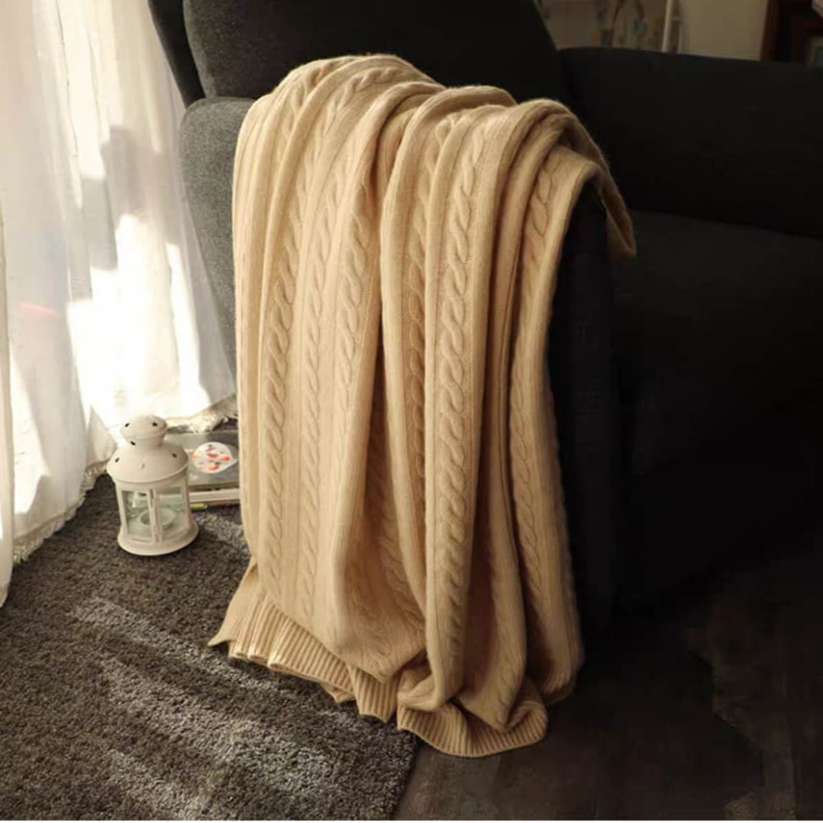 Cozy neutral-toned cashmere throw blanket in a minimalist living room