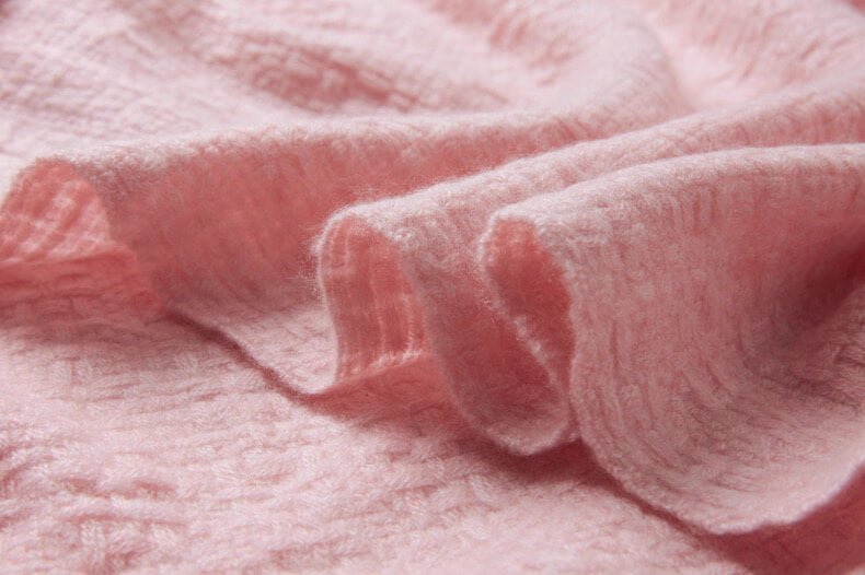 Romantic pink cashmere wrap with airy texture and raw fringes”