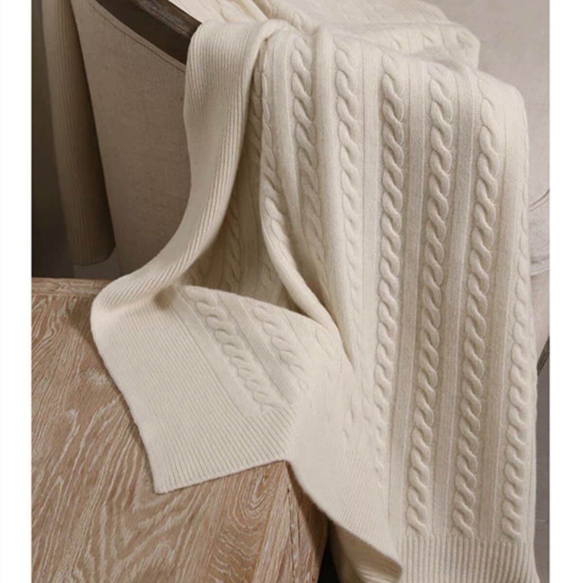 Off-white cable knit cashmere throw with soft natural texture