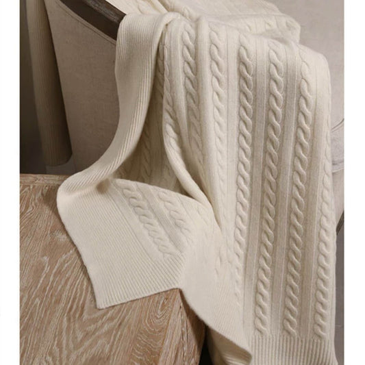 Off-white cable knit cashmere throw with soft natural texture