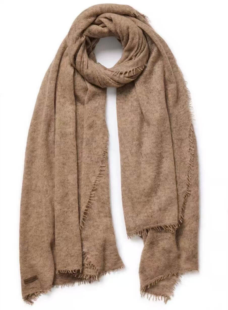 A light brown fringed cashmere scarf draped in a loop on a white background.
