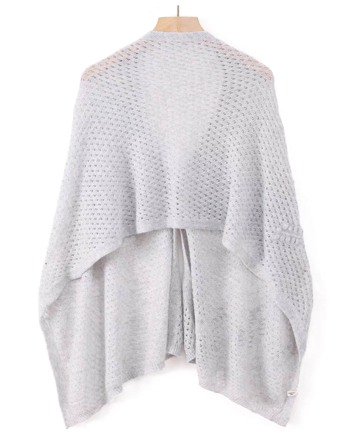A light gray open-knit poncho cashmere scarf with covered button