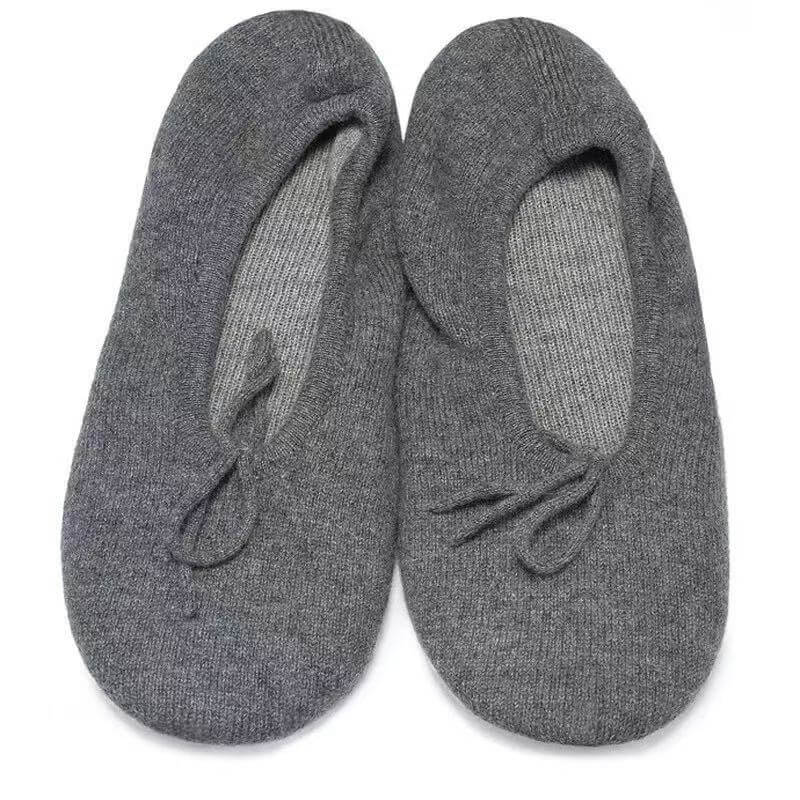 A pair of gray knit slip-on pure cashmere women slippers with small bow details on the front