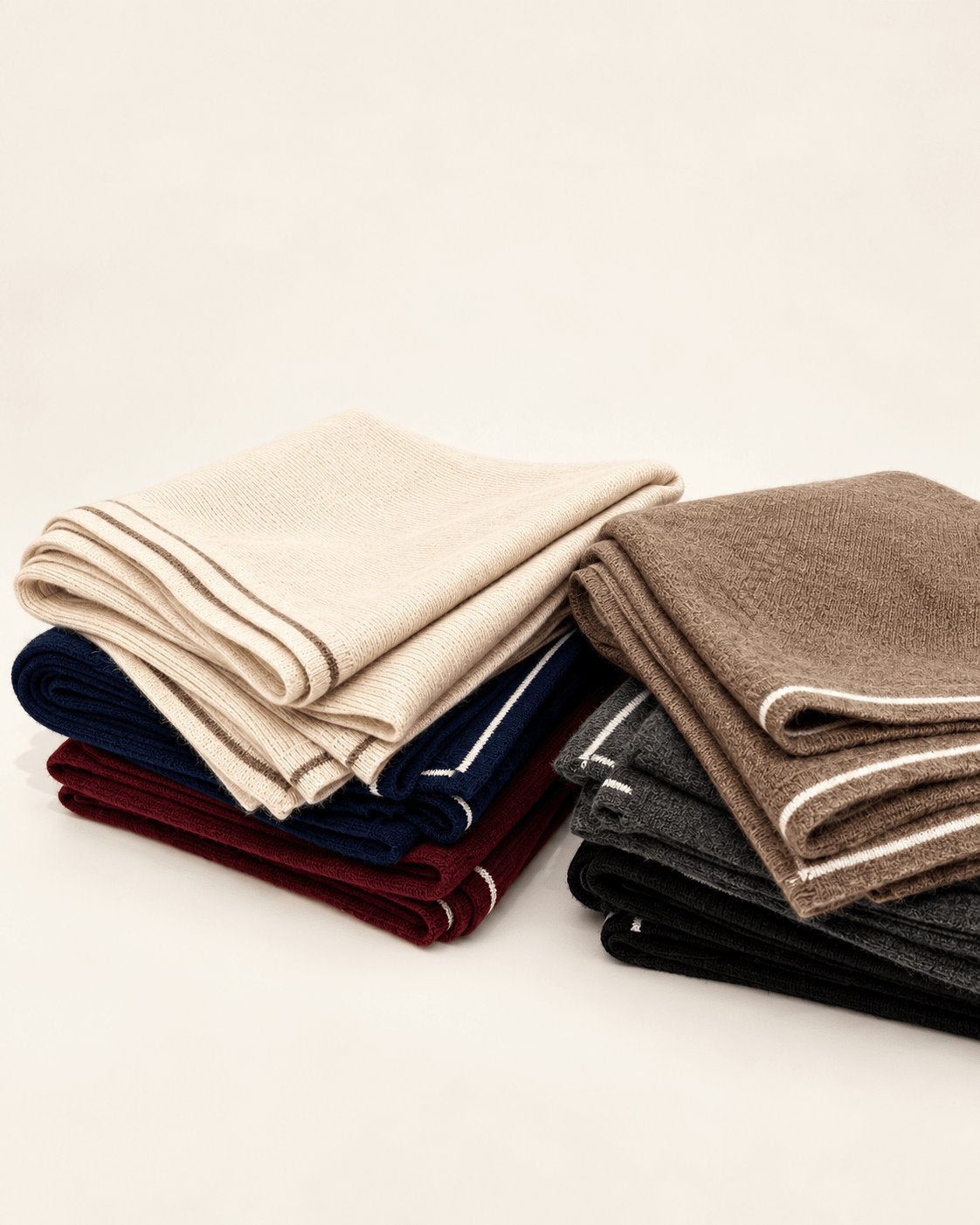 Dark gray cashmere knit square scarf displayed flat with fine texture and contrasting white border stripes.