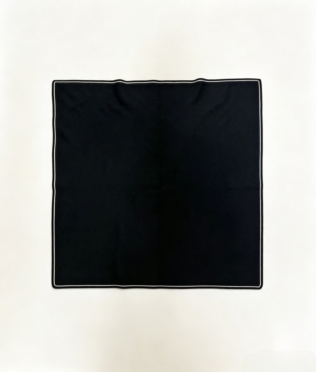 Folded black 100% cashmere knit square scarf with elegant white double-stripe border, 70 x 70 cm.