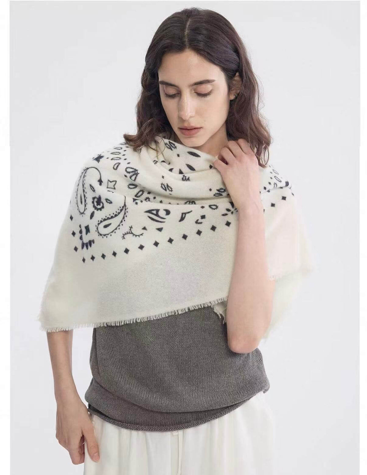 Ivory 100% cashmere paisley scarf styled over the shoulders