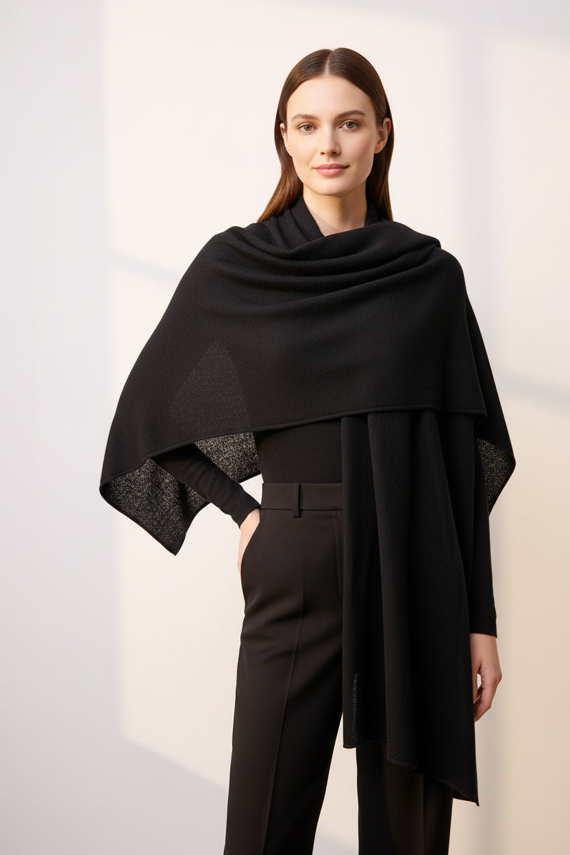 Woman wearing solid black cashmere scarf with trench coat in autumn park