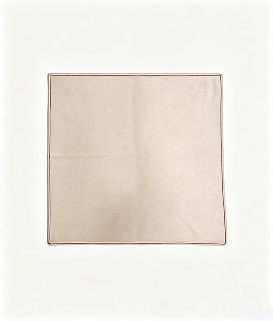 Soft beige 100% cashmere knitted square scarf with delicate brown double-stripe edging, neatly folded.