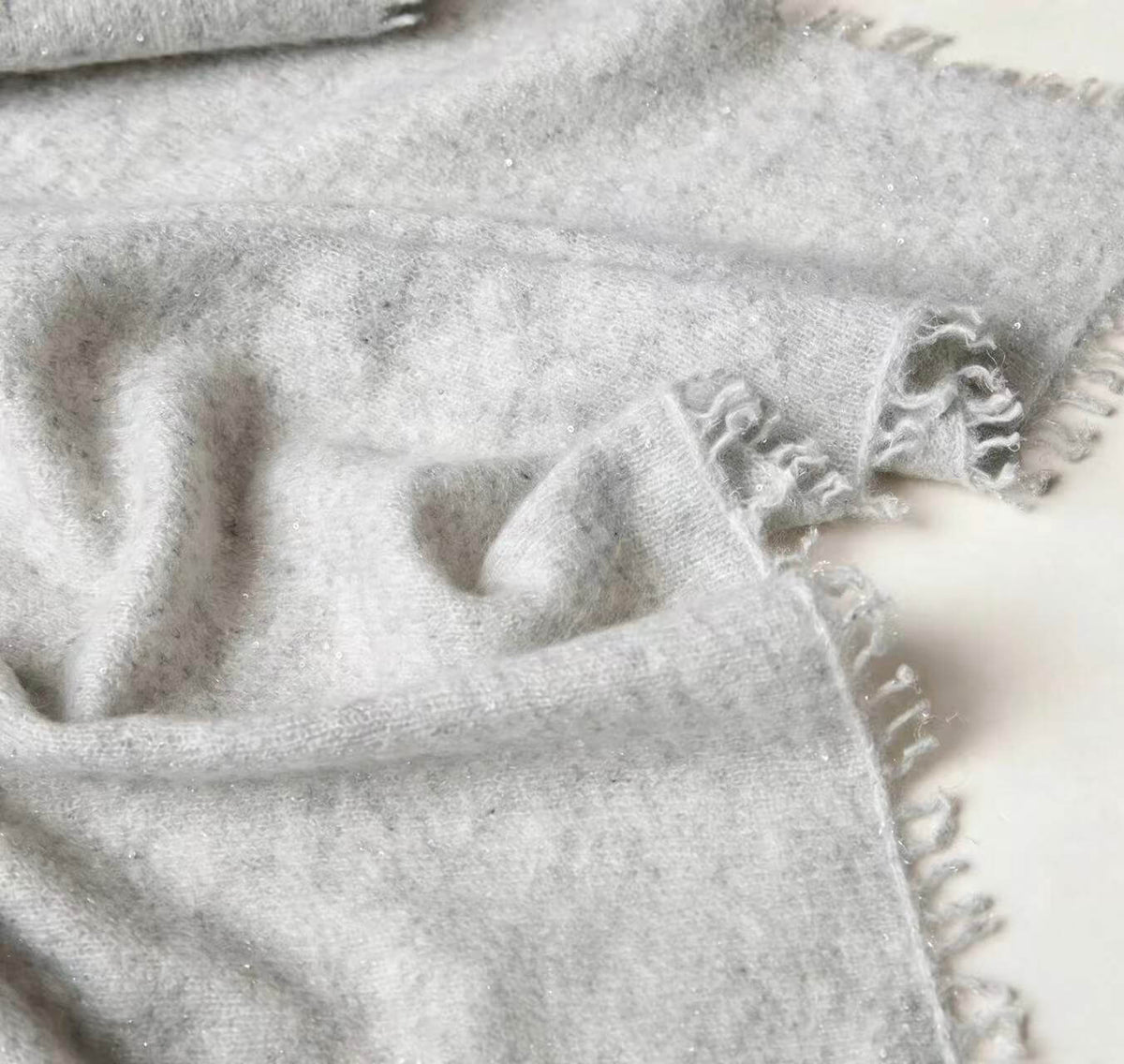 Soft fringed cashmere wrap with grey and beige gradient colors
