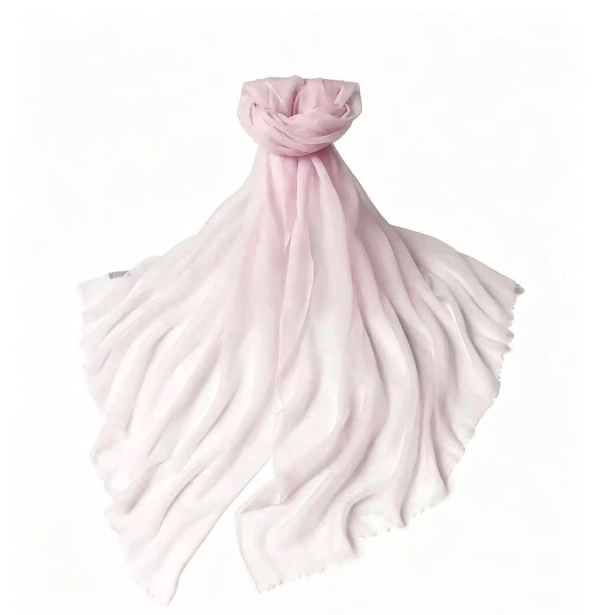 Women's featherweight 100% cashmere scarf and wrap in soft blush pink and white, elegantly draped to showcase its airy
