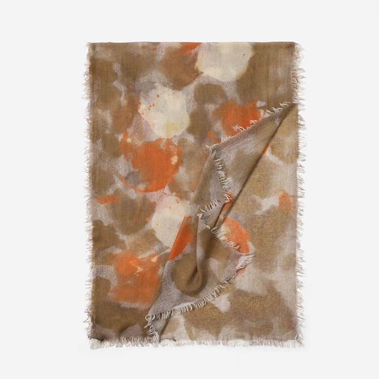 	Watercolor-style printed cashmere wrap draped over shoulders