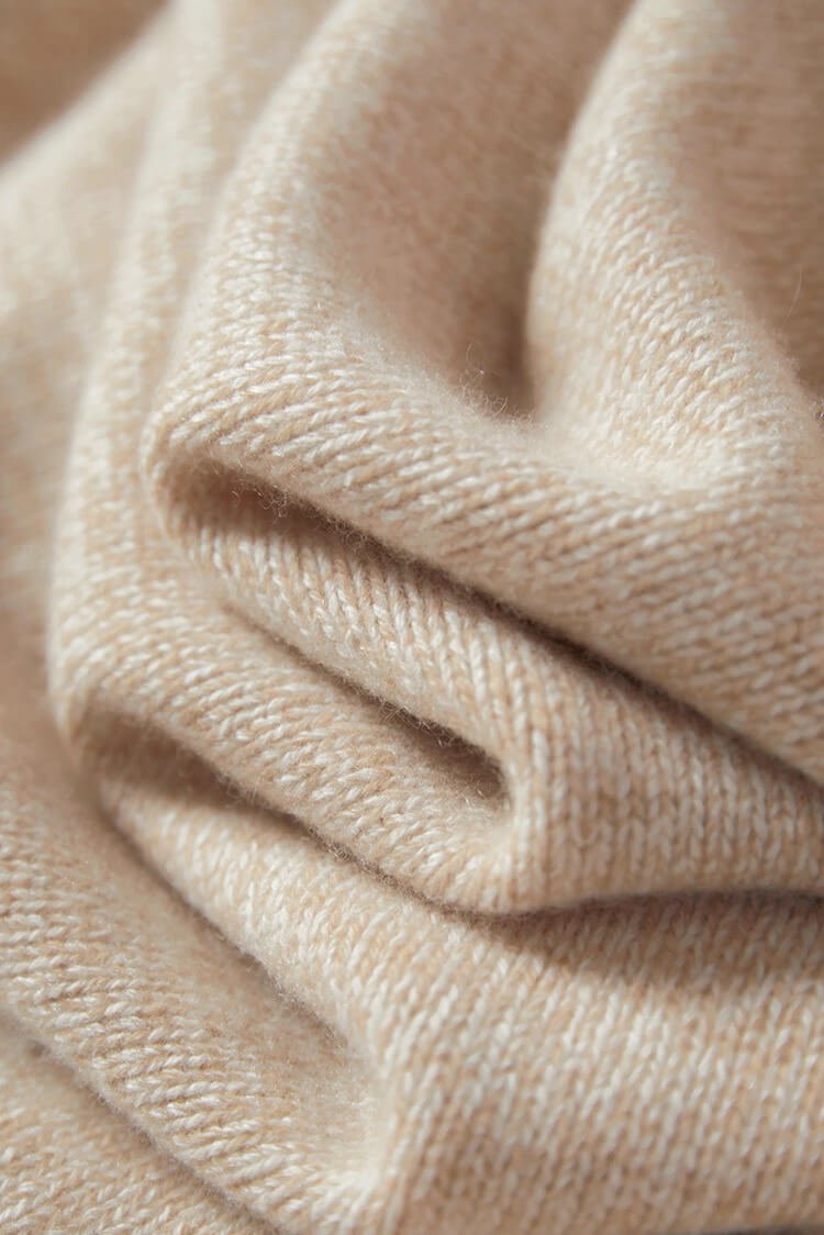Natural rolled hem detail on beige cashmere sweater