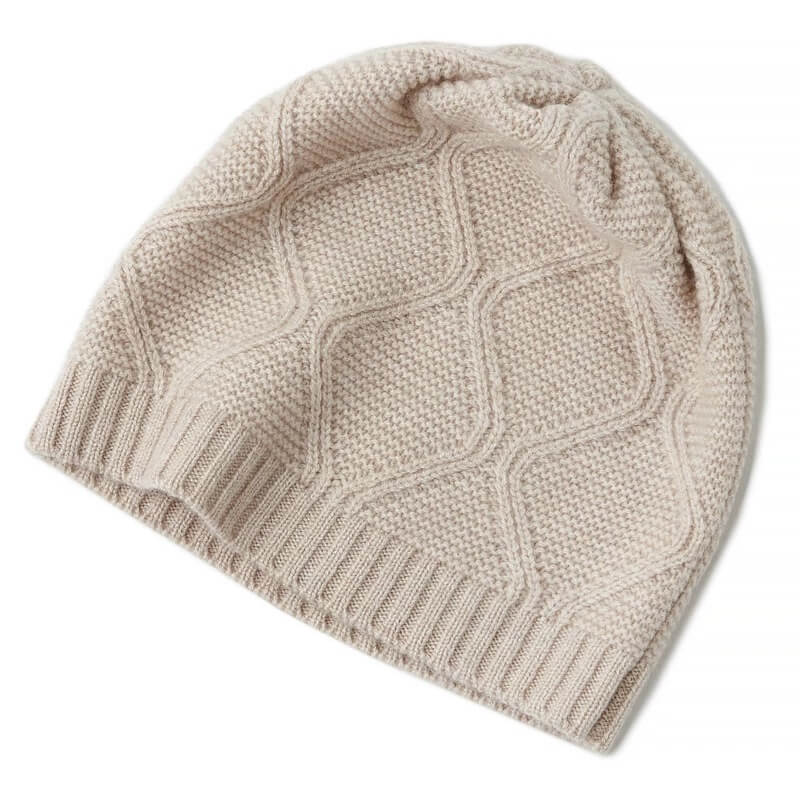 Beige knitted pure cashmere beanie on a white background