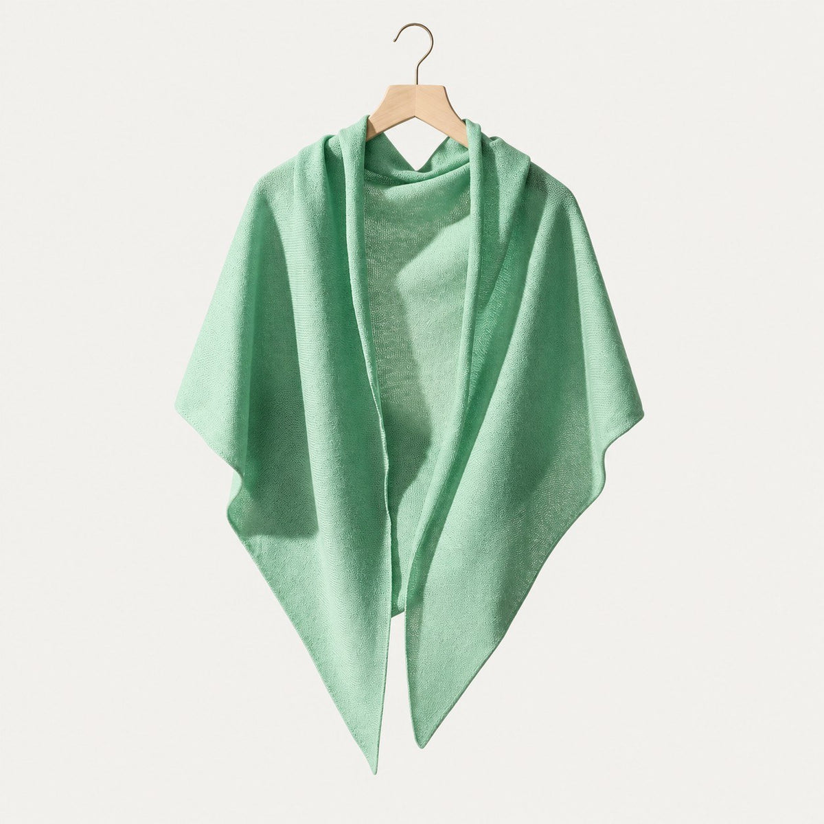 Mint green lightweight 100% cashmere triangle scarf on a hanger