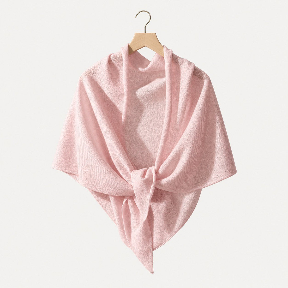 Pink lightweight 100% cashmere triangle scarf on a hanger