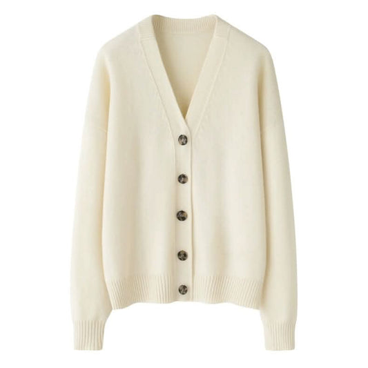 White chunky cashmere cardigan with ribbed hem and V-neck draped on a chair