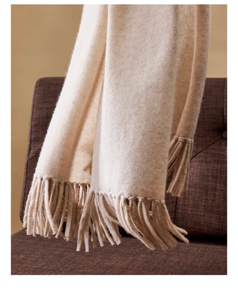 Luxurious women’s cashmere wrap in camel brown with hand-fringed edges