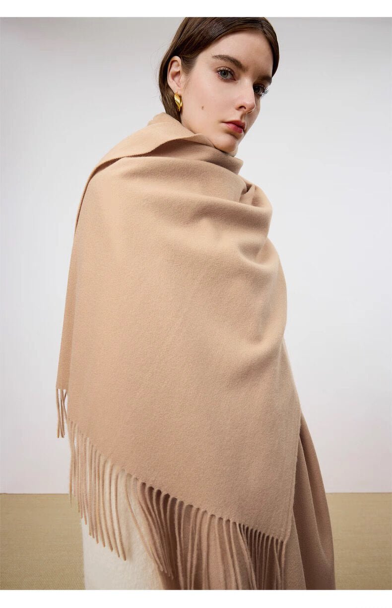 Woman wearing solid color cashmere wrap in oatmeal tone