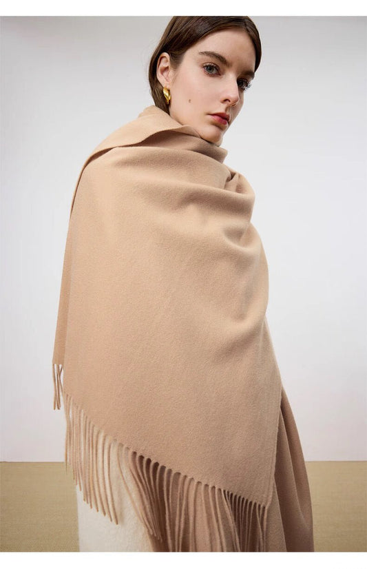 Woman wearing solid color cashmere wrap in oatmeal tone