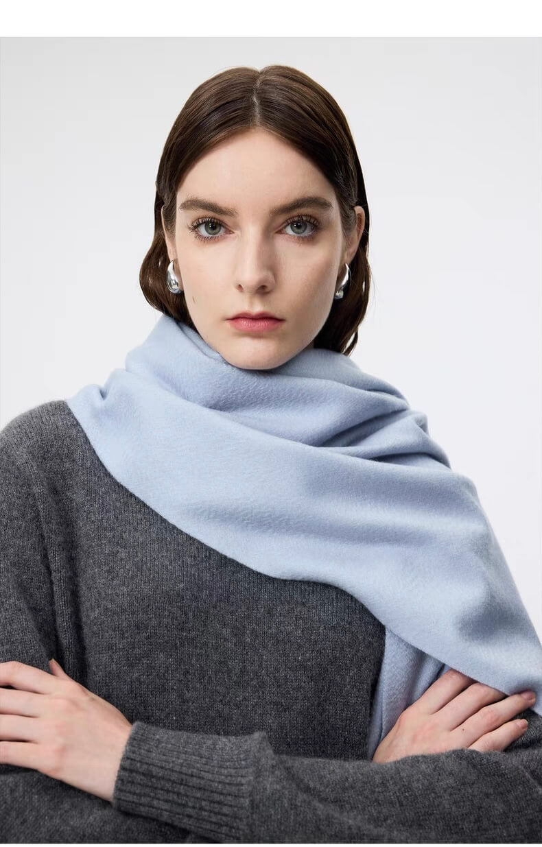 Woman wearing a light blue 100% cashmere scarf for women