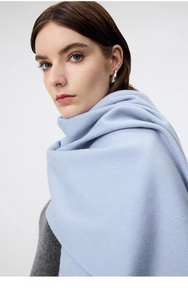Woman wearing a light blue 100% cashmere scarf for women