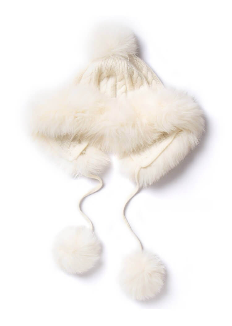 	Close-up of detachable fox fur pom poms on cashmere hat
