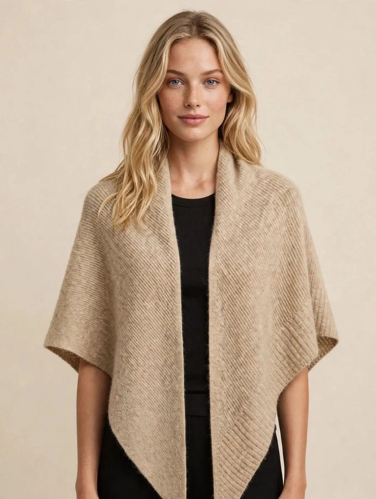 Model wearing the beige 100% cashmere ribbed triangle scarf as a shoulder wrap